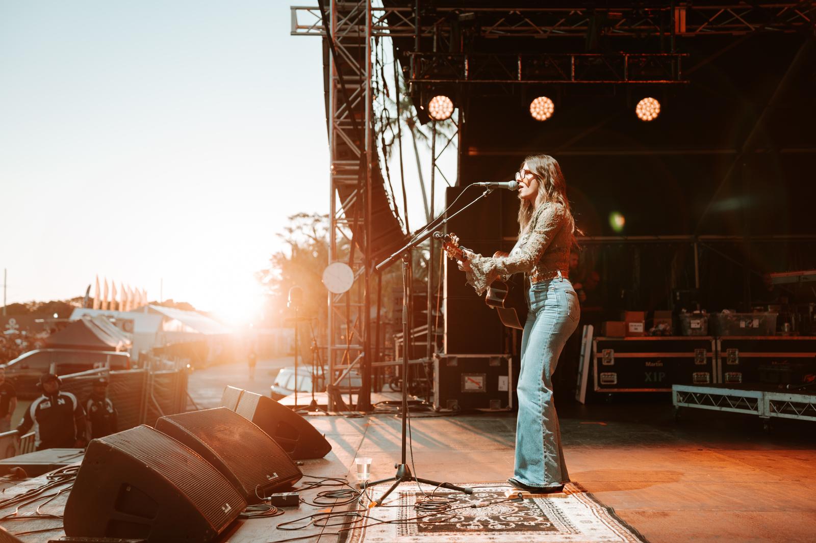 Bianca Joulianou singing live on stage at golden hour